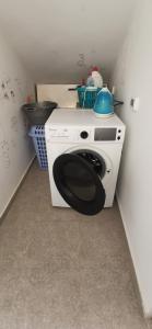 a washing machine in a corner of a kitchen at Villa B&B in Sousse