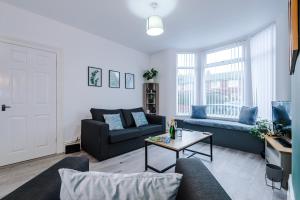 a living room with a couch and a table at Stunning 3-bed home in Anfield by 53 Degrees Property, Ideal For Big Groups, FREE parking! in Liverpool