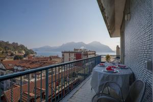 a table on a balcony with a view of a city at L’Attico di Susanna in Verbania