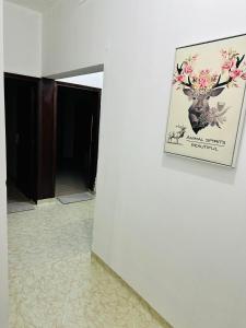 a picture of a deer on a wall in a hallway at Big bedroom in Sharjah