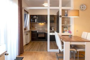 a kitchen with a table and a dining room at CariSSA AparthotelFerienwohnung in Bad Bevensen