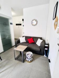 uma sala de estar com um sofá e uma mesa em Studio coin nuit, Entre plage et centre em Marselha
