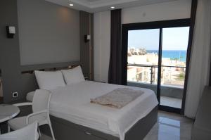 Postel nebo postele na pokoji v ubytování Akdeniz Yaşam Otel