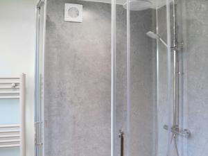 a shower in a bathroom with a glass door at Cartwheel Cottage in Hayton