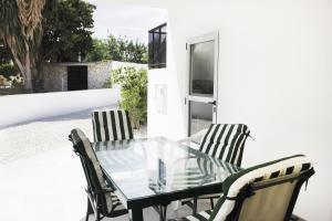 a glass table and chairs on a patio at Apartamento Centrico en Albir in Albir