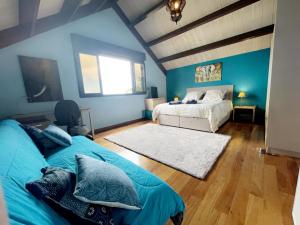 1 dormitorio azul con 2 camas y ventana en Villa Hermès Chambre bleue océan, en Saint-Pierre