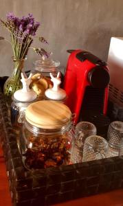 a table with jars of food and a vase with flowers at Vila Monte Cunha - Chalés in Cunha