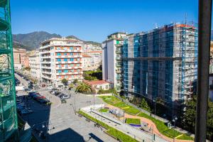 a view of a city with tall buildings and a street at B&B Pietre Preziose in Salerno