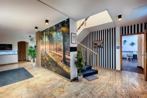 an office lobby with a large painting on the wall at Home Hotel in Dortmund