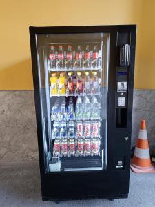 a vending machine filled with lots of bottles of soda at Pension Eder in Bruck an der Leitha