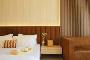 a hotel room with a bed and a chair at Hotel Adora in New Delhi +10 photos