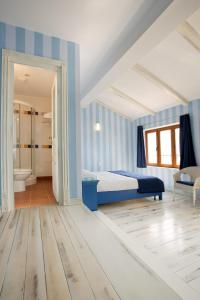 a blue bedroom with a bed and a bathroom at Arcadia Hotel - Marina Regia Residence in Mamaia Sat/Năvodari +18 photos