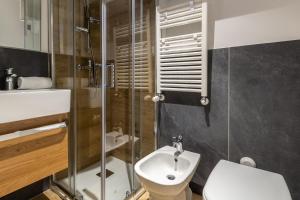 a bathroom with a toilet and a sink and a shower at HelloCHALET - Friends Ski House in Breuil-Cervinia +18 photos