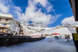 a snow covered mountain in the distance with a building at HelloCHALET - Friends Ski House in Breuil-Cervinia