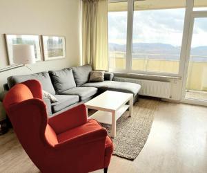 uma sala de estar com um sofá, cadeiras e uma mesa em Schöne Aussicht - b50247 em Hohegeiß