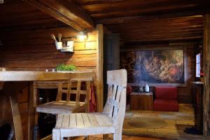 a wooden room with a chair and a painting on the wall at Wooden love nest in Vransko