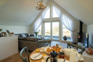 a living room with a table with food on it at Capercaillie Cottage - Luxury converted steading in Perth +17 photos