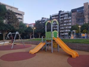 a playground in a park with two slides at Skeggi Space in Bari