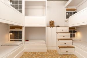 a bedroom with two beds and white cabinets at Casa Gracia in Barcelona