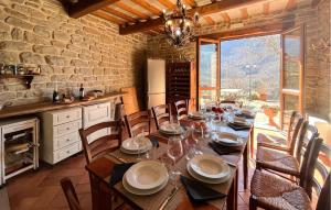 a dining room with a wooden table and chairs at Lovely Home In Pian Del Ponte in Serravalle