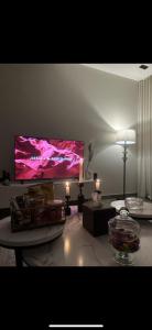 a living room with a large flat screen tv at شقة جديدة بتصميم فاخر نظام مودرن in Riyadh
