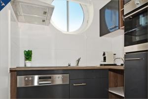 a kitchen with a sink and a window at Haus Usedom Appartement Meeresklang in Ostseebad Koserow