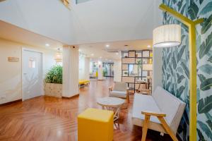 an office lobby with chairs and a table at Bloom Hotel - Medicity Gurugram, Near Medanta Hospital in Gurgaon