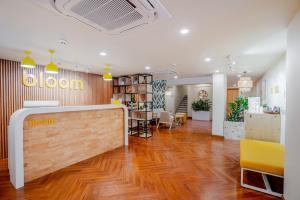 a lobby of a salon with a wooden floor at Bloom Hotel - Medicity Gurugram, Near Medanta Hospital in Gurgaon