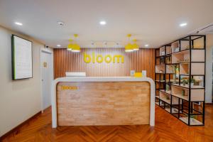 Bloom Hotel - Medicity Gurugram, Near Medanta Hospital في جورجاون: مكتب فيه جدار خشبي عليه كلمة ازهر