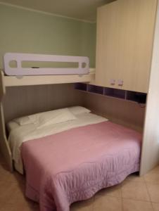 a bedroom with a bed with a pink blanket at Alloggio Turistico in Viterbo