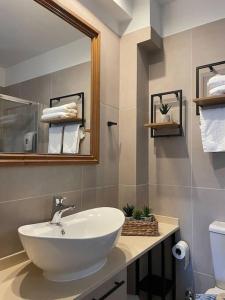 a bathroom with a white sink and a mirror at Harbour lights by Smaris Collection in Sissi +38 photos