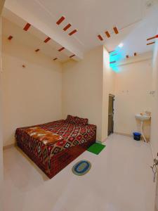a bedroom with a bed and a sink in it at Aayu Parth Residency 300 M from Ram Janam Bhumi in Ayodhya