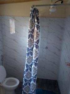 a shower curtain in a bathroom with a toilet at Recanto do Meu Tio in Chimoio