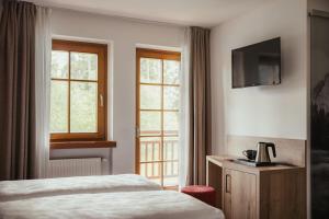 Postel nebo postele na pokoji v ubytování Hotel Leonard