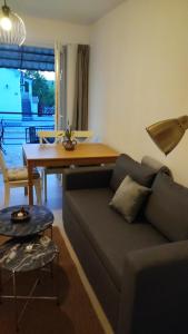 a living room with a couch and a dining table at Small apartment near the beach in Gornji Karin in Anić