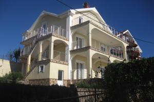 a large white building with balconies on top of it at Penthouse apartment with panoramic oceanview in Krimovice