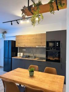 a kitchen with a wooden table with chairs and a tableasteryasteryasteryasteryastery at Green Escape Mavrovo in Mavrovo