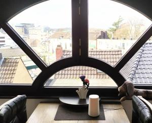 a view of a window with a table in front of it at Super Penthouse #9 oder Studio #6 mit Aufzug, Terrasse & Wintergarten im Zentrum in Eschweiler +11 photos