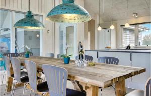 a dining room with a wooden table and chairs at Amazing Home In Bogense With Sauna in Bogense