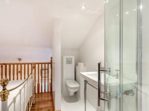 a bathroom with a toilet and a glass shower at Little Batley House in Westgate-on-Sea
