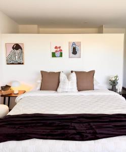a bedroom with a large white bed with two pillows at Amazing view Architech Home 8Minutes to Hobart CBD in Hobart