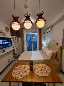 a living room with a large bed and a table at Seo staycation in Lapu Lapu City