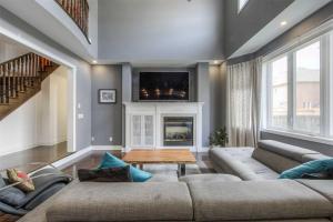 a living room with a couch and a fireplace at Luxurious Stay in the Heart of Community in Brampton