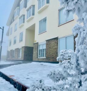 a building with snow in front of it at Maribel Chic Shack in Sierra Nevada