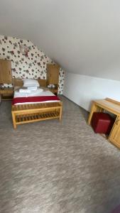 a bedroom with two beds in a attic at Pension La Viorel Isaila in Sibiu