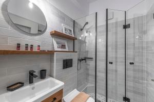a bathroom with a shower and a sink and a mirror at Villa Ilias in Firostefani