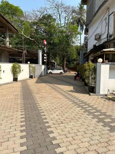 a cobblestone street in front of a building at SGHACI INN in Kozhikode