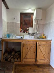 a kitchen with a wooden counter with a sink and a counter at Planinska kuca Bogdanovic in Jarmenovci +63 photos