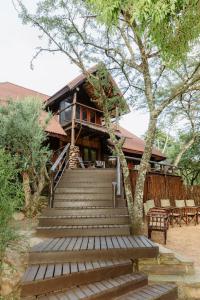 a building with stairs leading up to a house at Duma Manzi Eco Lodge & Spa in Richmond