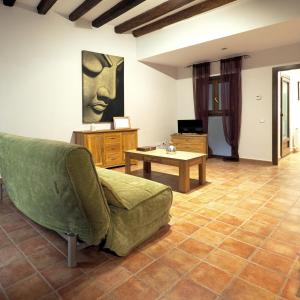 a living room with a couch and a table at Apartamentos Angelus Plaza Mayor de Graus in Graus +32 photos